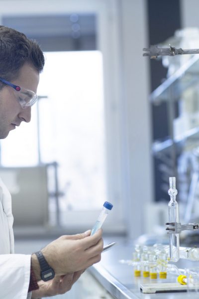 Chemist working in lab with test tube