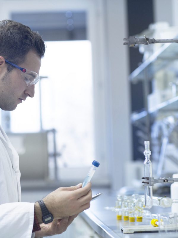 Chemist working in lab with test tube