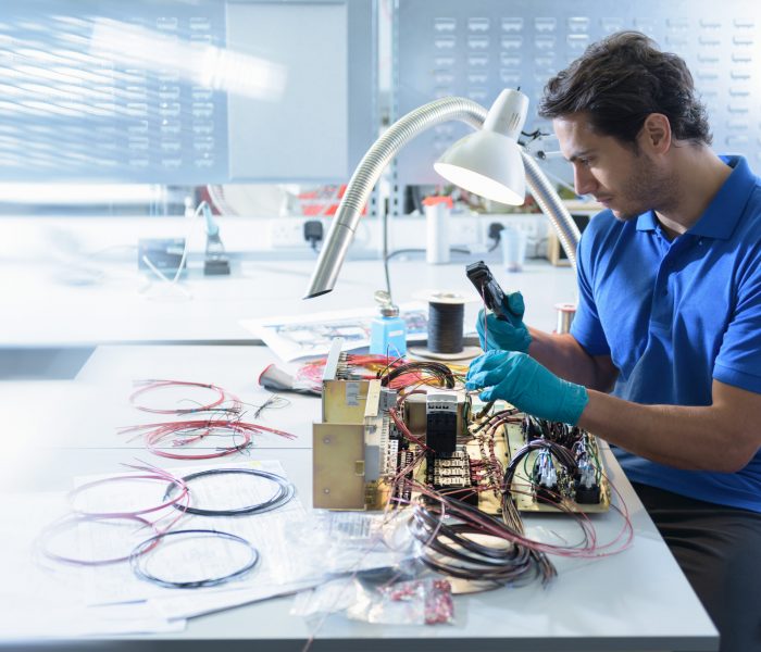 Worker assembling electronics in electronics factory